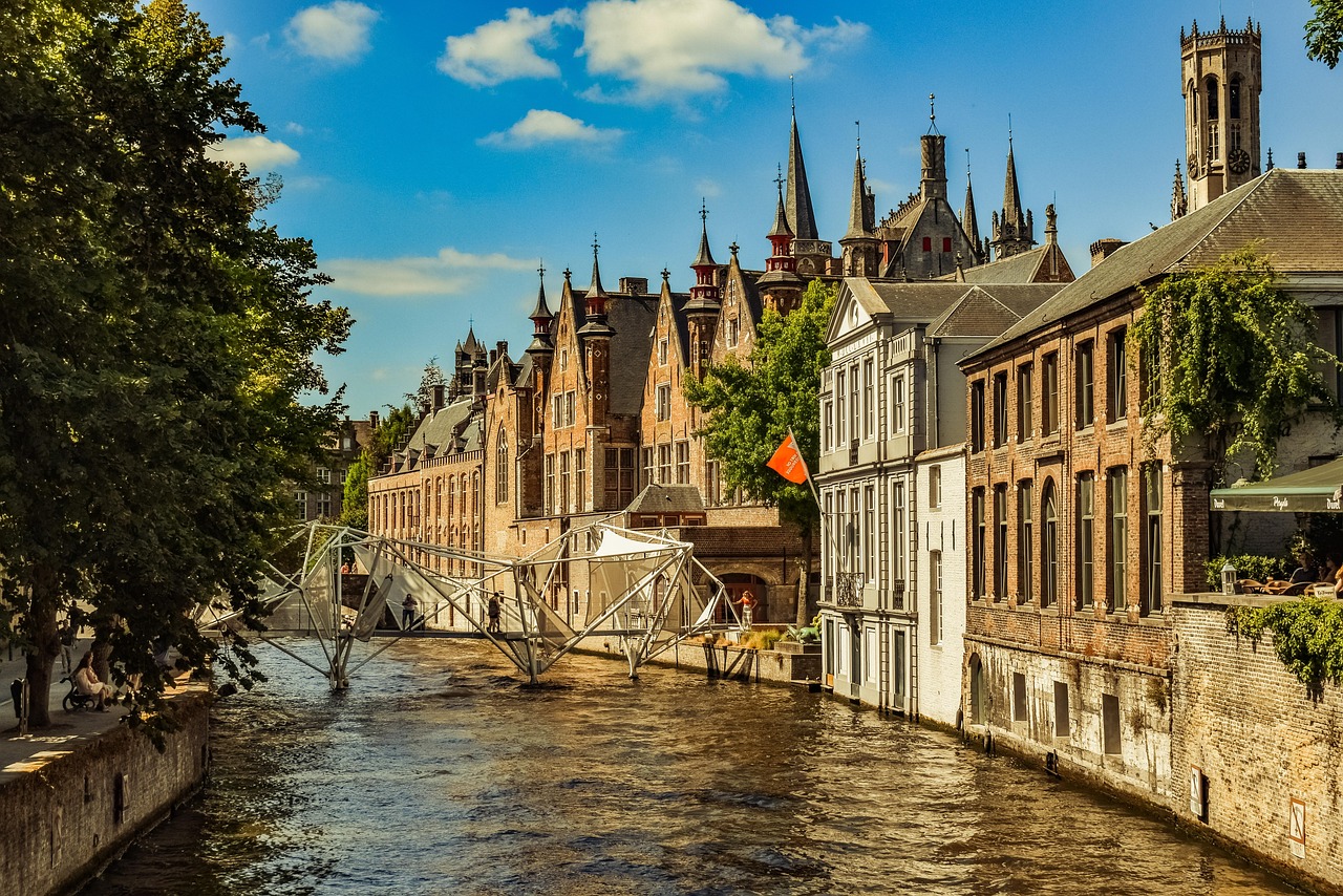 In this imagery, a bridge, body of water, trees, buildings, flags, plants, individuals, and a sky with clouds are depicted in the background.\n
