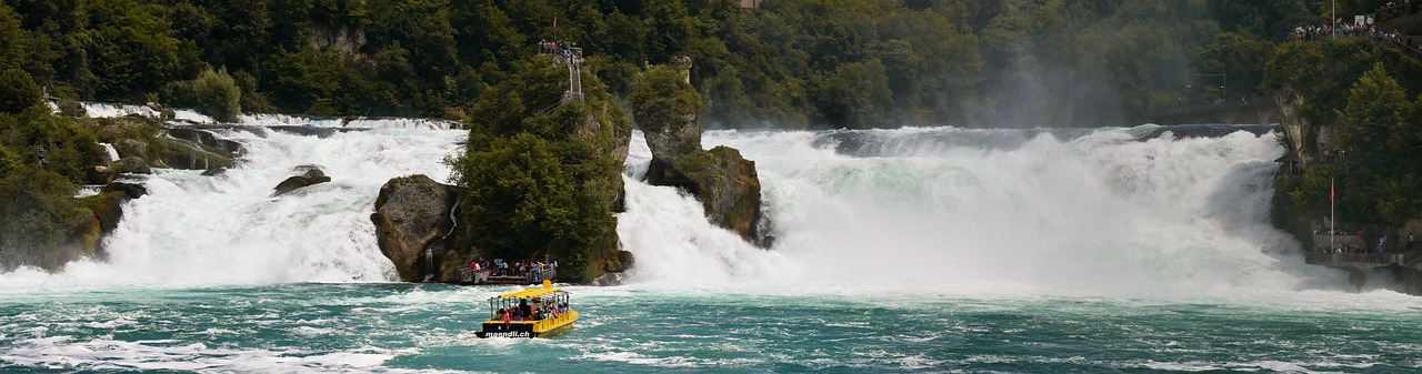 In this image, a boat is depicted on the water's surface. The background features a waterfall, trees, and people.\n
