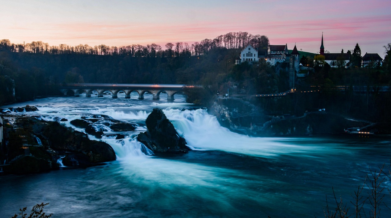 In this image, a bridge, water, trees, buildings, and sky are visible.\n
